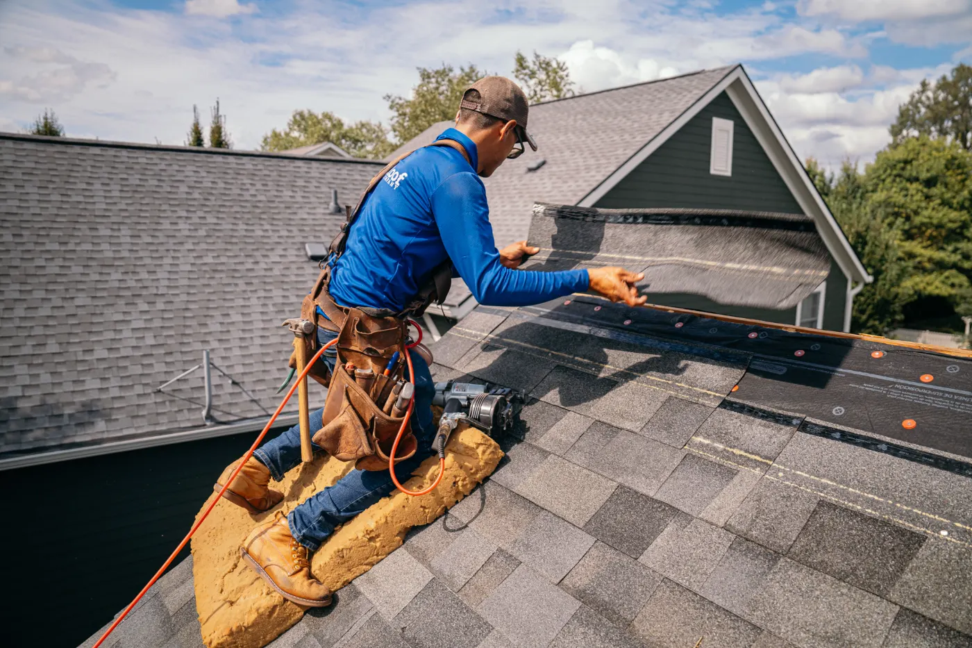 Emergency tarping on a Lawrence roof